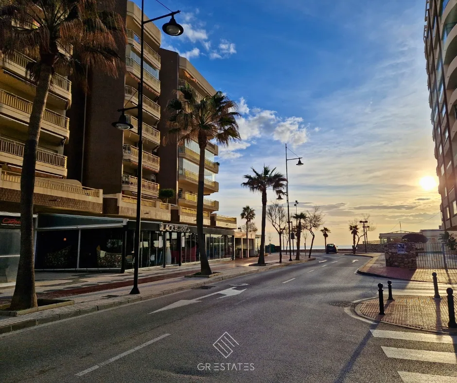 Winter sun over an empty Costa del Sol beach promenade